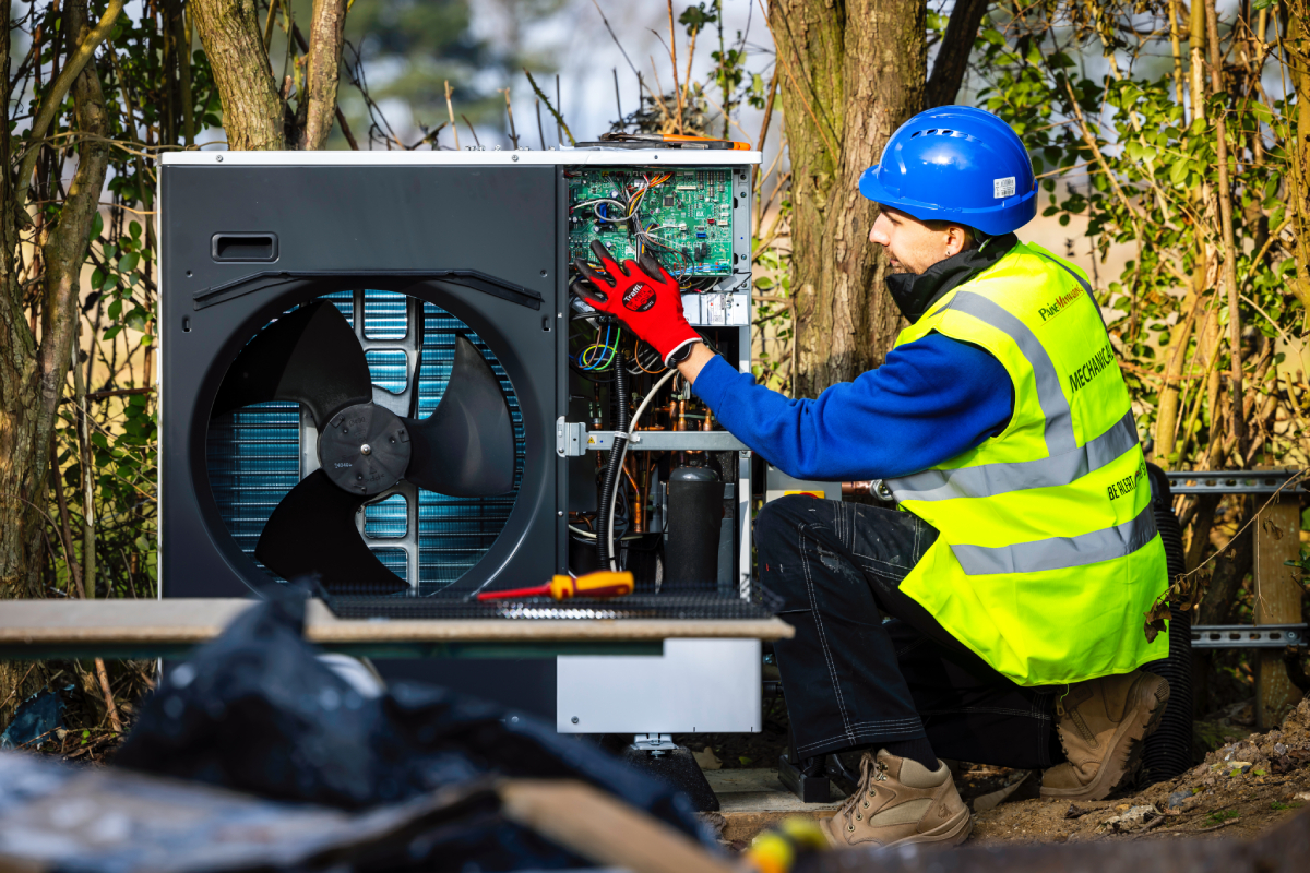 Paine Manwaring renewable energy team member installing an air source heat pump.