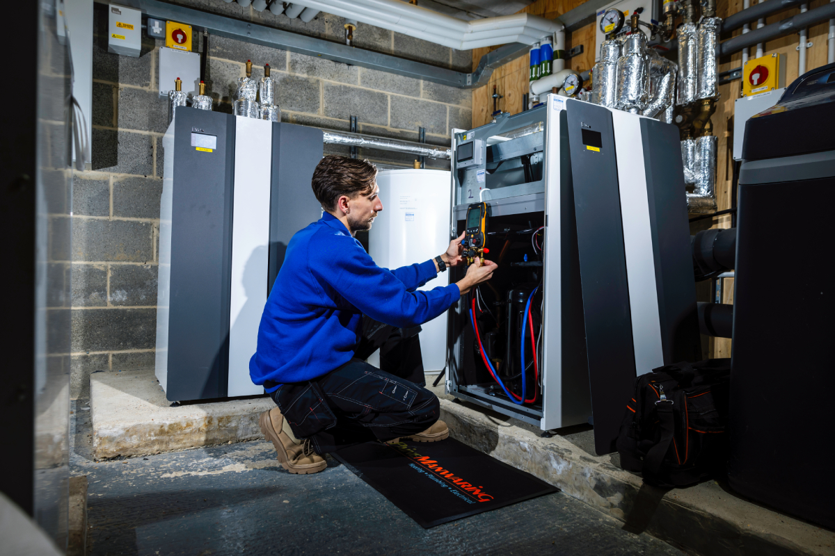 Paine Manwaring renewable energy team member installing a ground source heat pump.