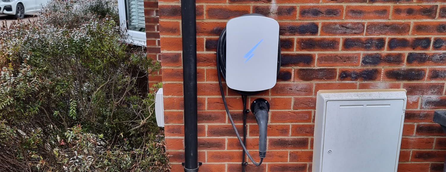 Domestic EV charger installation An EV charger professionally installed at a home in the UK by Paine Manwaring.